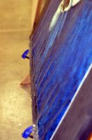 Angle shows detail of vertical planar distortion (cockling) along upper edge. Similar occurrence also appears at bottom though less pronounced.